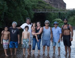 Group stands in river, ankle-deep